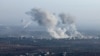 In this picture taken from the northern Syrian village of Ariha, smoke billows from the site of clashes and mutual shelling on the outskirts of the city of Saraqib in Syria's Aleppo province on Nov. 28, 2024. 