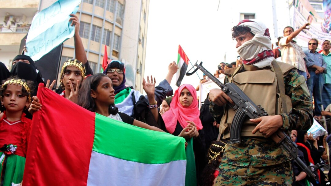 FILE - Supporters of southern separatists backed by the Unite Arab Emirates hold UAE flags during a rally, amid a standoff with the internationally recognized government backed by Saudi Arabia, in Aden, Yemen, Sept. 5, 2019. 