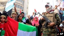 FILE - Supporters of southern separatists backed by the Unite Arab Emirates hold UAE flags during a rally, amid a standoff with the internationally recognized government backed by Saudi Arabia, in Aden, Yemen, Sept. 5, 2019. 