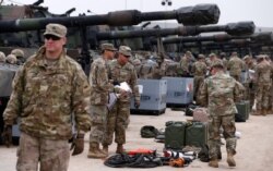 U.S. troops check military equipment after their deployment to Drawsko Pomorskie, Poland, March 21, 2019.
