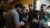 People exchange money in the city of Idlib, Syria, June 20, 2020. In the northwestern province of Idlib, the last remaining Syrian rebel stronghold, some people have started using the Turkish lira instead of the Syrian pound. 