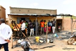 FILE - Residents gather at the site of an attack in the village of Solhan, in Yagha province bordering Niger, Burkina Faso, June 7, 2021. (Burkina Faso Prime Minister's Press Service/Handout via Reuters)