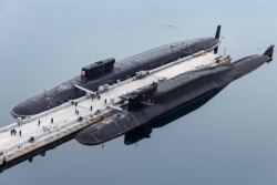 In this handout photo released by Russian Defense Ministry Press Service, Russian nuclear submarines Prince Vladimir, above, and Yekaterinburg are seen at a Russian naval base in Gazhiyevo, Kola Peninsula, April 13, 2021.