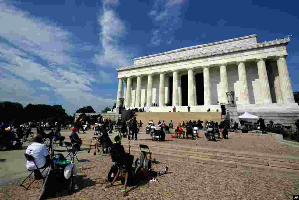 People attend the March on Washington, Aug. 28, 2020, at the Lincoln Memorial in Washington, on the 57th anniversary of the Rev. Martin Luther King Jr.&#39;s &quot;I Have A Dream&quot; speech. 