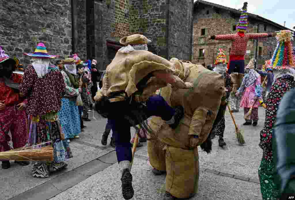 &quot;Zaldiko&quot; (man of the horse) hits Ziripot (C) to make him fall down during an ancient carnival in the northern Spanish Navarre village of Lantz, Spain.