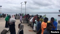 Travellers are seen gathered at the Lamu jetty following an attack by Somalia's Islamist group al Shabaab on a military base in Manda, Lamu, Kenya January 5, 2020. REUTERS/Abdalla Barghash NO RESALES. NO ARCHIVES