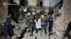 Rescuers carry the body of a woman found under debris of an apartment building which was hit by a Russian missile strike, amid Russia's attack on Ukraine, in Kryvyi Rih, Dnipropetrovsk region, Ukraine, in this handout picture released November 12, 2024. 