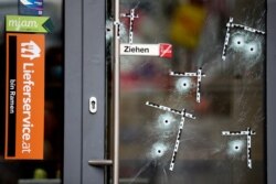 Bullet holes are marked on a door at the crime scene in Vienna, Austria, Nov. 4, 2020.