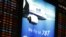 An electronic board displaying flight schedule and advertising of All Nippon Airways Boeing Co's 787 plane is seen at New Tokyo international airport in Narita, east of Tokyo, Jan. 9, 2013.