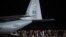 Afghan refugees, fleeing the capital Kabul, exit an US air force plane upon their arrival at Pristina International airport near Pristina on August 29, 2021.- Kosovo has offered to take in temporarily thousands of Afghan refugees evacuated by US flight.