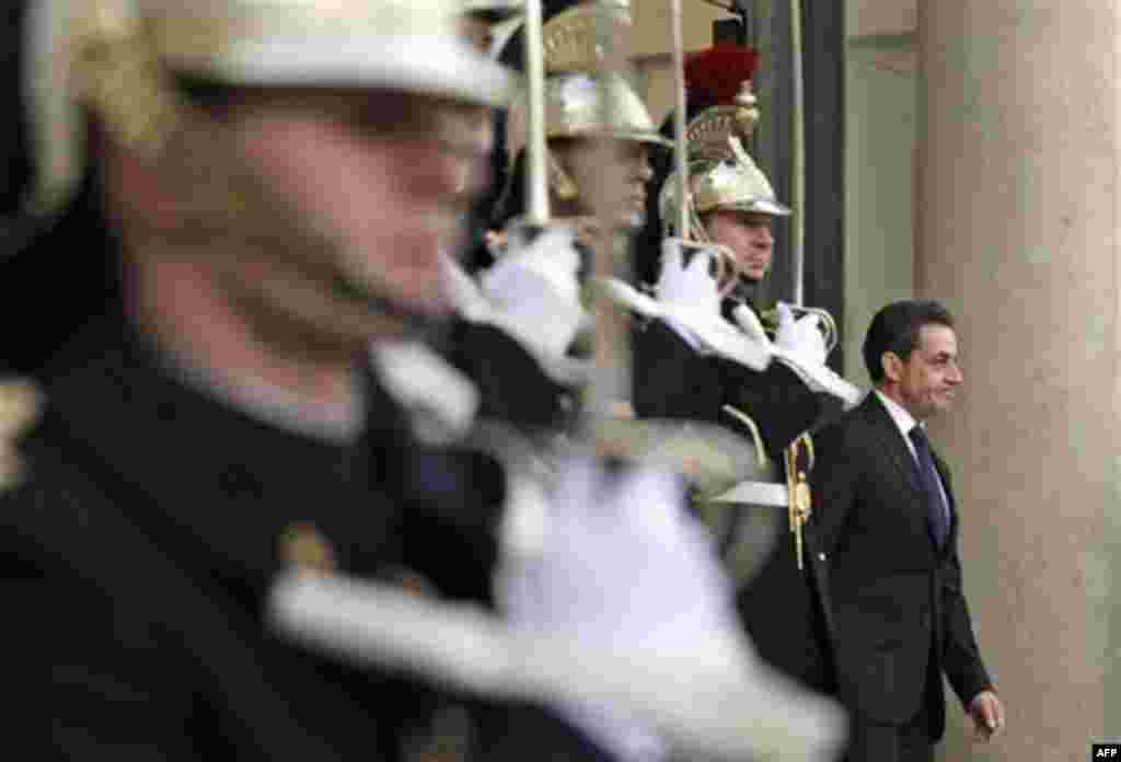 French President Nicolas Sarkozy, right, waits for Italian Prime Minister Mario Monti before a meeting at the Elysee Palace, in Paris, Friday, Jan. 6, 2012. The leaders of France and Italy will meet in Paris to discuss a spiraling debt crisis that is thre