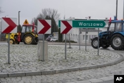 Polish farmers drive tractors in a convoy in Minsk Mazowiecki, Poland, Feb. 20, 2024, as they intensify a nationwide protest against the import of Ukrainian foods and European Union environmental policies, .