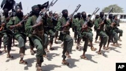 FILE - Hundreds of newly trained al-Shabab fighters perform military exercises in the Lafofe area, south of Mogadishu, Somalia, Feb. 17, 2017. 