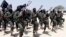 FILE - Hundreds of al-Shabab fighters perform military exercises in the Lafofe area 18 kilometers south of Mogadishu, Somalia, Feb. 17, 2017. 