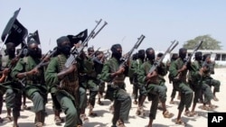 FILE - Hundreds of newly trained al-Shabab fighters perform military exercises in the Lafofe area 18 km south of Mogadishu, Somalia, Feb. 17, 2017. 