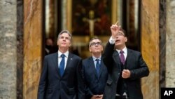 Secretary of State Antony Blinken, left, accompanied by tour guide Alessandro Conforti, right, and Chargé d'Affaires of the U.S. Embassy to the Holy See Patrick Connell, center, gets a tour of the Sala Regia at the Vatican in Rome, June 28, 2021.