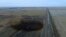 FILE - This aerial photo shows a spill from TransCanada Corp.'s Keystone pipeline, Nov. 17, 2017, near Amherst, S.D. The spill, originally estimated at 210,000 gallons of oil, is now deemed to have been about 407,000 gallons.