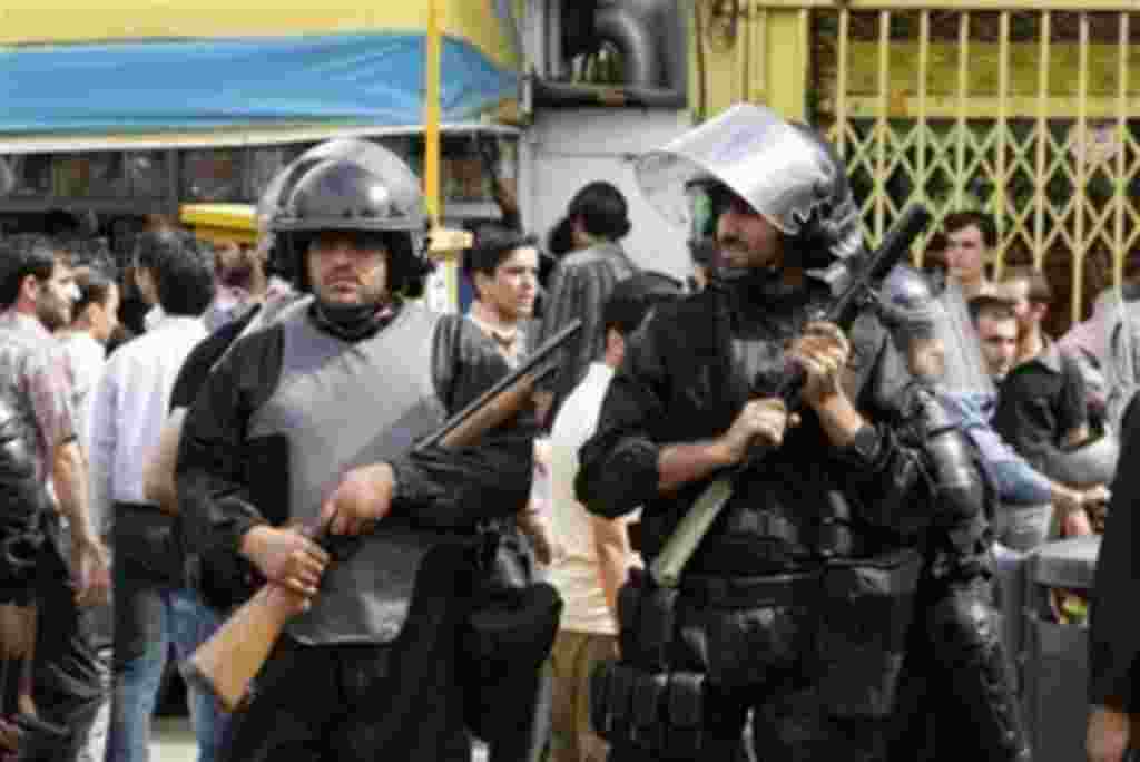 In this image dated Monday, June 15, 2009, Iranian anti-riot police officers secure the area during a mass protest over the June 12 disputed presidential election, in Tehran, Iran. Iran's supreme leader has imposed his will on the streets with security f