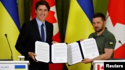 Canadian Prime Minister Trudeau and Ukraine's President Zelenskiy show signed joint declaration during press conference in Kyiv