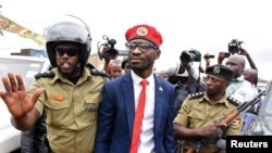 Ugandan musician turned politician, Robert Kyagulanyi also known as Bobi Wine is detained by policemen in Kasangati town, Wakiso district, Uganda, Jan. 6, 2020. 