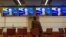 A man follows the media conference of European Council President Van Rompuy at the European Council building, Brussels, Feb. 8, 2013.