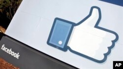 FILE - The Facebook "Like" icon displayed outside of company headquarters, Menlo Park, California, Jan. 2012.