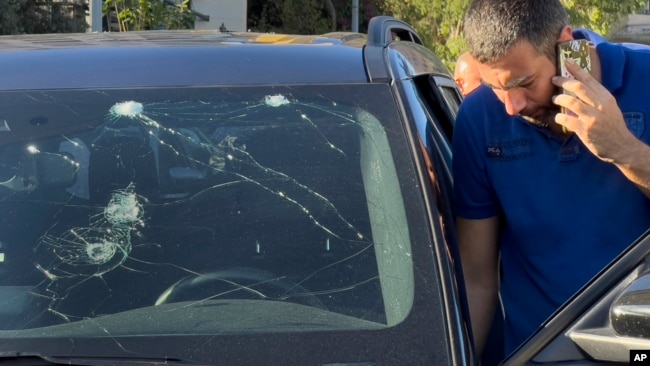 A police officer inspects a car in which a hand-held pager exploded, in Beirut, Sept. 17, 2024.