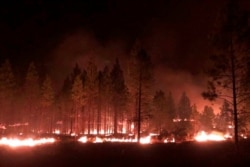 FILE - The Bootleg Fire burns at night near Highway 34 in southern Oregon, July 15, 2021, in this photo provided by the Bootleg Fire Incident Command.