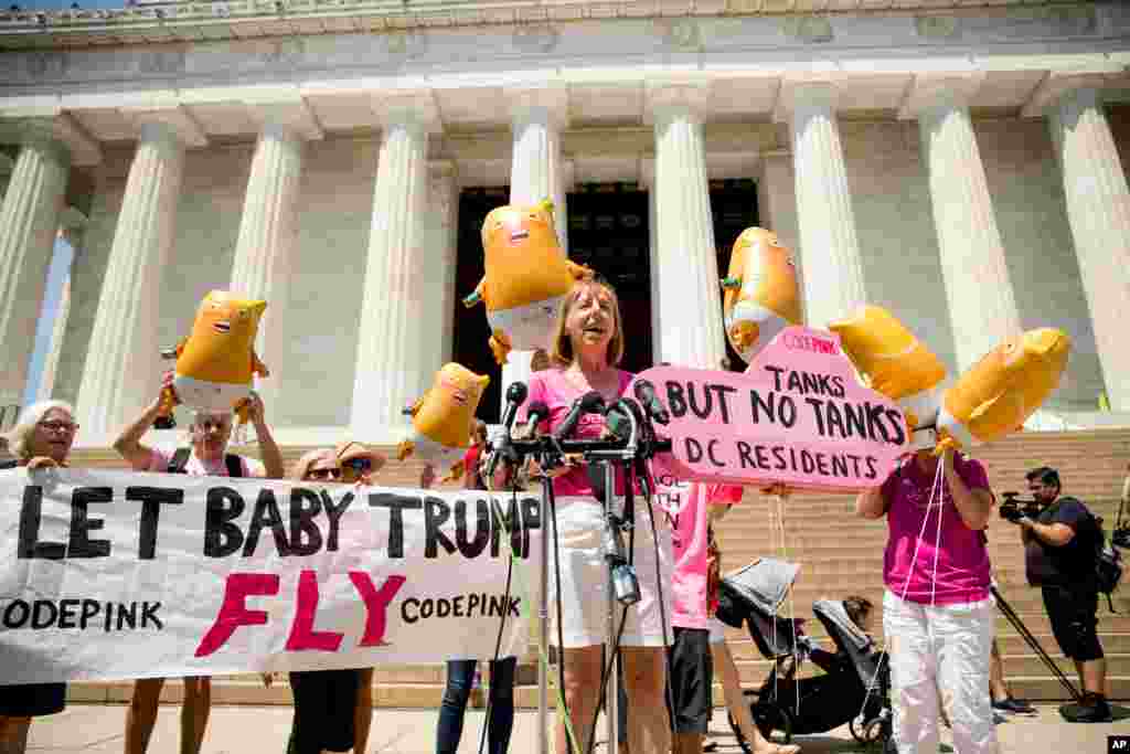 U.S. activist Medea Benjamin, co-founder of the anti-war group Code Pink holds a sign that reads &quot;Tanks But No Tanks DC Residents,&quot; as she speaks at a news conference in front of the Lincoln Memorial in Washington, July 2, 2019.