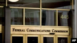 FILE - The entrance to the Federal Communications Commission (FCC) building is seen in Washington, June 19, 2015.