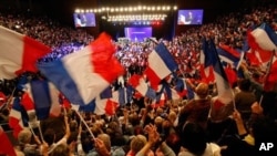 Supporters of France's president and candidate for re-election in 2012, Nicolas Sarkozy, wave French national flags, during a campaign meeting, in Toulon, southern France, May 3, 2012. 