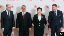 Prime ministers of the Visegrad group countries, from left, Czech Republic's Prime Minister Bohuslav Sobotka, Hungarian Prime Minister Viktor Orban, Polish Prime Minister Beata Szydlo and Slovakian Prime Minister Robert Fico pose for media before their meeting in Warsaw, Poland, Tuesday, March 28, 2017.