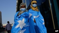 FILE - Survivors of a boat tragedy that killed dozens of Somali migrants off the coast of Madagascar arrive at Aden Adde International Airport in Mogadishu, Somalia, Nov. 7, 2024.