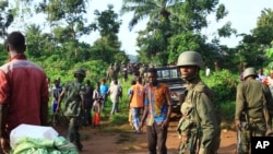 In this photo taken Friday, Oct 5, 2018, Congolese Soldiers patrol in an area civilians were killed by The Allied Democratic Forces rebels in Beni, Eastern Congo. 