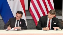  Paraguay Foreign Minister Rubén Ramírez Lezcano and U.S. Deputy Secretary of State Christopher Landau sign agreements during Deputy Secretary Landau's recent visit to the region. 