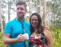 This 2016 photo provided by Cristina Miles shows her and her husband, Austin, in Palm Coast, Fla. Cristina's husband died after contracting COVID-19, and less than two weeks later, her mother-in-law succumbed to the virus.