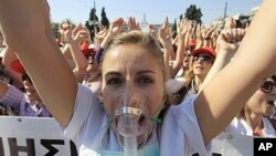 A nurse shouts slogans during a protest by hospital staff in Athens, October 13, 2011.