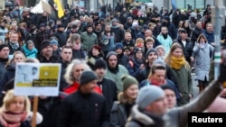 Protesters march during a demonstration against government measures to curb the spread of the coronavirus disease (COVID-19) in Magdeburg, Germany, January. 8, 2022.