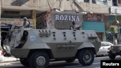 FILE - Army soldiers stand guard in their military vehicle in central Cairo, August 30, 2014.