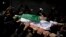 Palestinians carry the body of Tamir Abu al-Khair, 17, who was shot and killed on Saturday by Israeli troops during a protest next to the Israeli border, eastern Gaza Strip, out of the family home during his funeral in Gaza City, Sunday, March 31, 2019.
