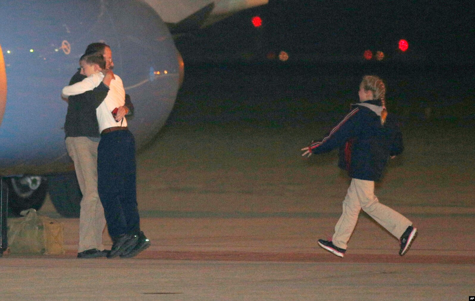 Jeffrey Fowle is greeted by his son and other family members upon his arrival, at Wright-Patterson Air Force Base, Ohio. Fowle was detained for nearly half a year in North Korea after leaving a Bible at a nightclub. Christian evangelism is considered a crime in North Korea.