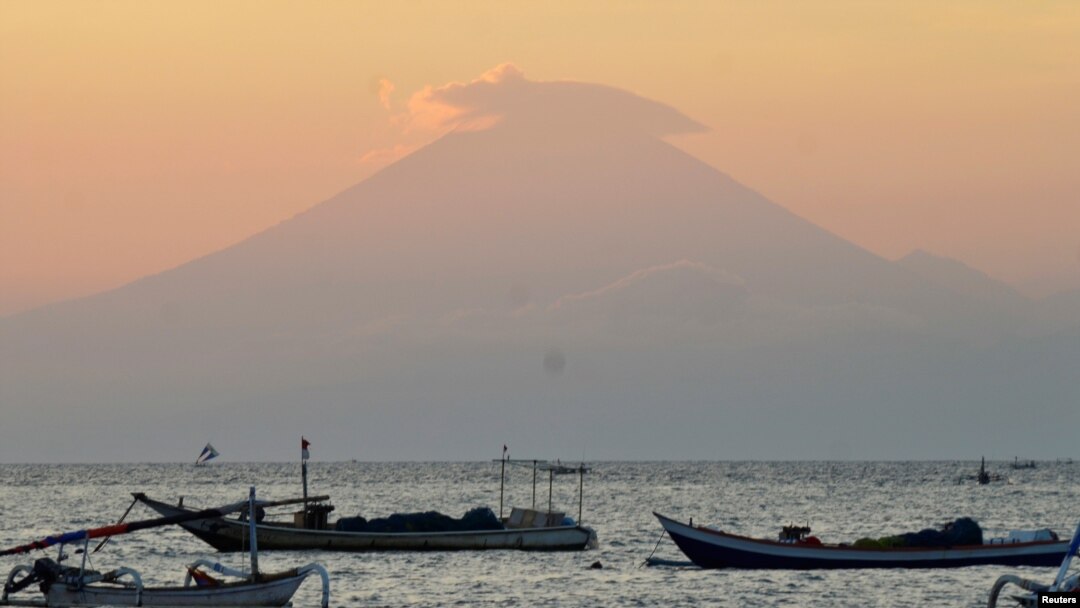 Mount Agung, an active volcano located on the resort island of Bali that has been placed on alert level 3 following recent seismic activity, is seen from Mataram on nearby Lombok island, Indonesia, Sept. 21, 2017, in this photo taken by Antara Foto. 