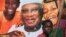 A boy sits in front of an electoral campaign poster for Malian presidential candidate Ibrahim Boubacar Keita, in Timbuktu, Mali, July 25, 2013.