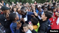 France's defender Benjamin Mendy is congratulated by supporters during a reception at the Elysee Presidential Palace after they won the Russia 2018 World Cup final football match, in Paris, France, July 16, 2018. 