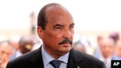 FILE - Mauritania's President Mohamed Ould Abdel Aziz wait for the arrival of his French counterpart Emmanuel Macron at Nouakchott airport, Mauritania, July 2, 2018. 