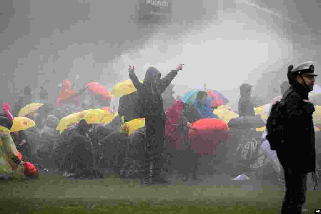 Dutch police uses a water cannon to break up a demonstration against coronavirus-related government policies including the curfew and the tight lockdown in Amsterdam, Netherlands.
