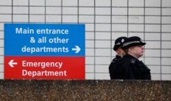 Police officers patrol outside a hospital where it is believed that Britain's Prime Minister Boris Johnson is undergoing tests after suffering from coronavirus symptoms, in London, April 6, 2020.