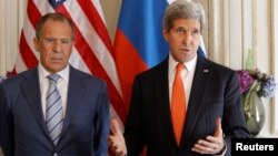 U.S. Secretary of State John Kerry (R) gestures as he stands with his Russian counterpart Sergey Lavrov, before their meeting in Paris, June 5, 2014. Both are in France for the 70th anniversary of the Normandy landings. REUTERS/Laurent Cipriani/Pool (FR