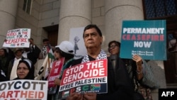 FILE — People holding placards as they take part in an interfaith protest in solidarity with Palestinian people outside the High Court in Cape Town on January 11, 2024.