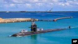 FILE - In this photo provided by US Navy, the submarine USS Oklahoma City returns to a US naval base in Guam, Aug. 19, 2021.